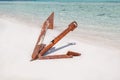 Gorgeous closeup view of old abandoned vintage ship rusty anchor, sitting on white sand beach