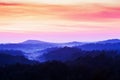 Gorgeous cloudscape over blue mountain range in the morning mist Royalty Free Stock Photo