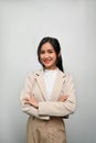 Gorgeous and confident Asian woman standing with arms crossed against a grey background Royalty Free Stock Photo