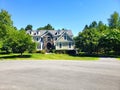 Gorgeous country home with large green lawn, landscaping and front yard parking Royalty Free Stock Photo