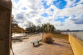 A gorgeous day at Mud Island Park along the Mississippi river with a red brick footpath, green benches, bare winter trees