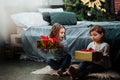 Gorgeous decorated bedroom. Christmas holidays with gifts for these two kids that sitting indoors in the nice room near