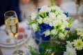 gorgeous decorated wedding table with bouquet and a glass of champagne in a restaurant