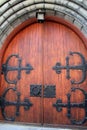 Gorgeous detail in heavy wood doors with elaborate black,metal hardware