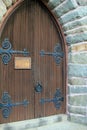 Gorgeous detail in old wood doors of stone church Royalty Free Stock Photo