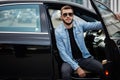 Gorgeous driver sitting on the car and posing to the camera Royalty Free Stock Photo