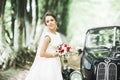 Gorgeous elegant bride posing near stylish retro black car Luxury wedding in vintage style. Portrait Royalty Free Stock Photo