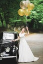 Gorgeous elegant bride posing near stylish retro black car Luxury wedding in vintage style. Portrait Royalty Free Stock Photo