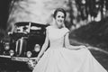 Gorgeous elegant bride posing near stylish retro black car Luxury wedding in vintage style. Portrait Royalty Free Stock Photo