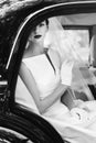 gorgeous elegant bride posing in stylish retro black car, sitting inside in saloon. luxury wedding in vintage style. portrait. b Royalty Free Stock Photo