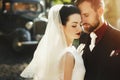 Gorgeous elegant bride and stylish groom embracing, gentle touch Royalty Free Stock Photo