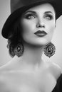 Gorgeous elegant woman in a hat posing in studio