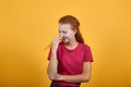 Gorgeous European girl laughing and closing her mouth with a right hand. Royalty Free Stock Photo