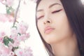 Portrait of a beautiful fantasy asian girl outdoors against natural spring flower background. Royalty Free Stock Photo