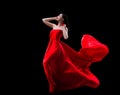 Gorgeous fashion model in red fluttered dress isolated on black background Royalty Free Stock Photo