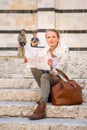 Gorgeous female tourist with a map discovering a foreign city