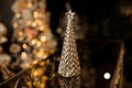 Gorgeous figurine in the form of golden Christmas tree stands on the table