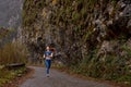 Gorgeous fit lady in sportswear exercising training running jogging in mountains