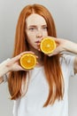 Gorgeous ginger girl with beautiful green eyes posing with fruit