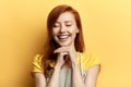 Gorgeous ginger girl with closed eyes laughing at somebody