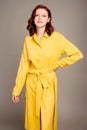 Gorgeous ginger woman in yellow shirt dress. Female bright look. Trendy trench