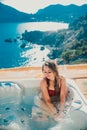 Gorgeous girl in an outdoor Jacuzzi with a beautiful view of the sea and mountains Royalty Free Stock Photo