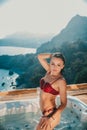 Gorgeous girl in an outdoor Jacuzzi with a beautiful view of the sea and mountains Royalty Free Stock Photo