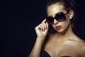 Gorgeous glam tanned model wearing trendy classic sunglasses