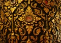 Gorgeous Gold and Black Vintage Thai Pattern on the Teak Lacquered Pillar in Wat Phumin Temple, Nan Province, Thailand