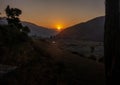 Gorgeous golden hour sunset in Uttarakhand\'s Himalayan Nag Tibba, featuring a round sun at its center