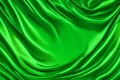 A gorgeous green shade of silk curtains. A satin fabric with waves texture pattern. smooth and glossy curtain material.