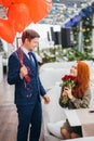 Gorgeous guy in tux and redhaired lady in dress on a date