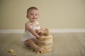 Gorgeous happy blue eyed baby boy in neutral tones turns one Royalty Free Stock Photo