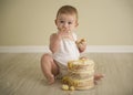 Gorgeous happy blue eyed baby boy in neutral tones turns one Royalty Free Stock Photo