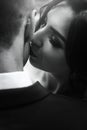 Gorgeous happy bride kissing handsome groom in neck sensual tender moment of luxury wedding couple in sunny outdoor. black white Royalty Free Stock Photo