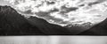 Gorgeous image of the snow capped mountains at the Wakatipu lake taken during an orange sunset in Queenstown, New Zealand