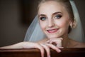 Gorgeous innocent blonde bride posing while sitting on chair, fa Royalty Free Stock Photo