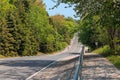 gorgeous inviting asphalt down hill road in park with people in background on sunny day