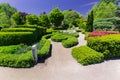 Gorgeous inviting view of botanical garden landscape on sunny spring day with people walking in background