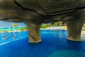 Gorgeous inviting view of Golden Tulip hotel swimming pool and grounds with people relaxing in background