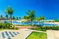 gorgeous inviting view of Golden Tulip hotel swimming pool and grounds with people relaxing in background on sunny day