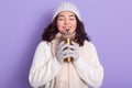 Gorgeous lady smeliing hot chocolate from thermo mug, keeping eyes closed, enjoying to drink hot beverage for basking in cold Royalty Free Stock Photo