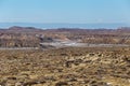 Gorgeous large valley with snow and rolling rocky hills on clear day