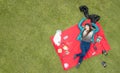 Gorgeous Latina student picnicking in the park, aerial view, available space for editing