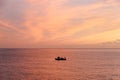 Gorgeous magnificent luminous wallpaper sundown background with fishermen on a boat fishing