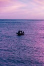 Gorgeous magnificent luminous wallpaper sundown background with fishermen on a boat fishing