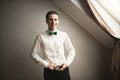 Gorgeous man, groom prepares for wedding ceremony in luxury hotel Royalty Free Stock Photo