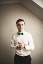 Gorgeous man, groom prepares for wedding ceremony in luxury hotel Royalty Free Stock Photo