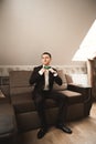 Gorgeous man, groom prepares for wedding ceremony in luxury hotel Royalty Free Stock Photo