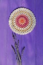 Gorgeous Mandala Crochet Doily and Lavander Flowers on Purple R Royalty Free Stock Photo